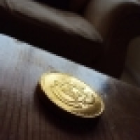 1253358_gold_coin_on_wooden_table
